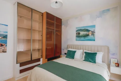 A furnished bedroom with a double bed and a large wardrobe. - image 6