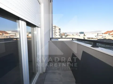 View from the balcony towards surrounding buildings and a construction site. - image 10