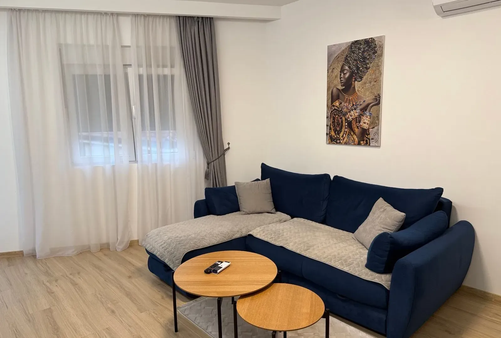 Living room with a sofa and coffee tables.