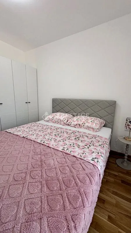 Bedroom with a double bed, wardrobe, and nightstand.