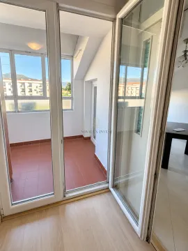 View through open balcony doors towards an enclosed terrace with ceramic tiles. - image 4
