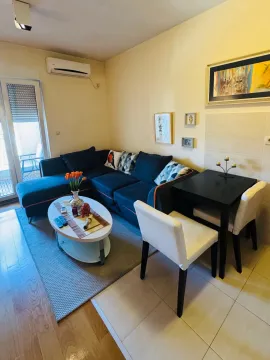 Living room with a sofa, coffee table and dining table. - image 4