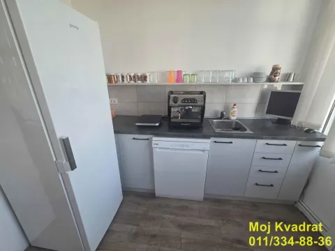 Small kitchen with white cabinets, a refrigerator, and a sink. - image 11