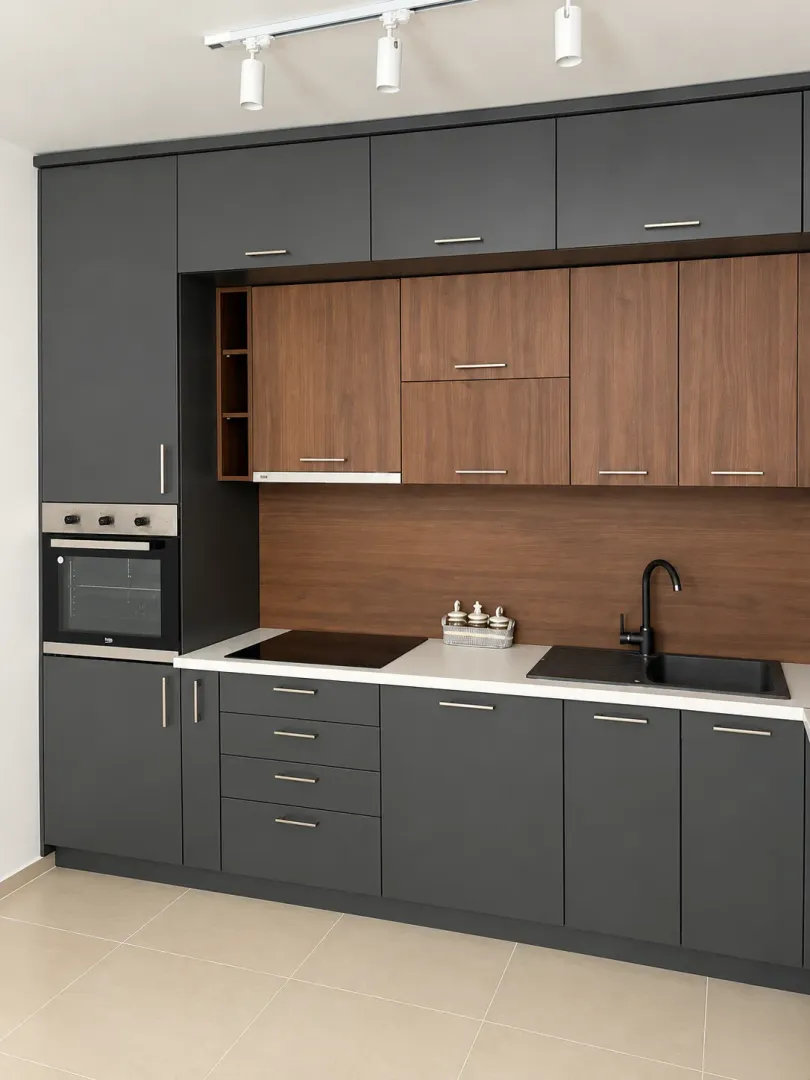 Modern kitchen with dark cabinets and wooden details.