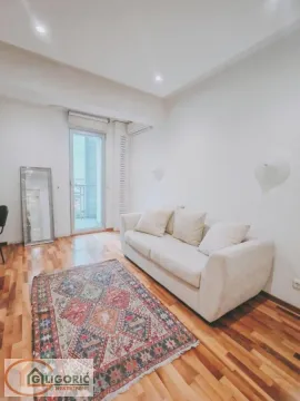 Living room with a beige sofa, colorful rug, and access to the terrace. - image 16