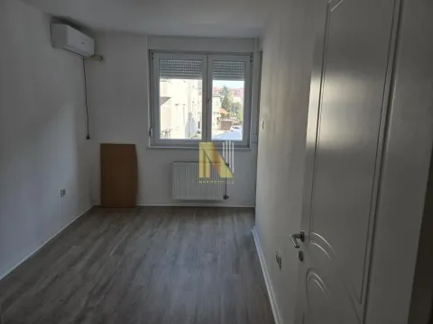 Empty room with laminate flooring, air conditioner, and window. - image 6