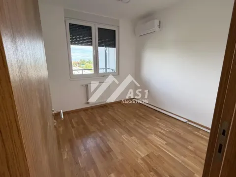 Empty room with hardwood floors and an air conditioning unit. - image 5