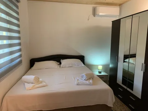 Furnished bedroom with a double bed and a wardrobe. - image 7