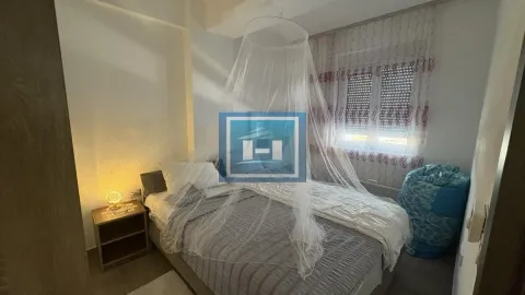 Furnished bedroom with a double bed and a nightstand. - image 12