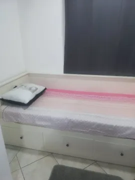 A simple bed with drawers in a bedroom. - image 6