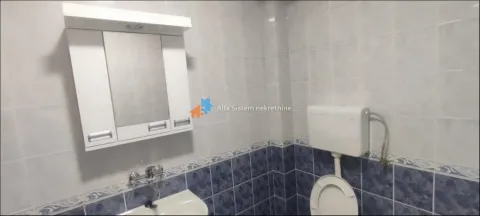 Bathroom equipped with a sink, mirror, and toilet. - image 18