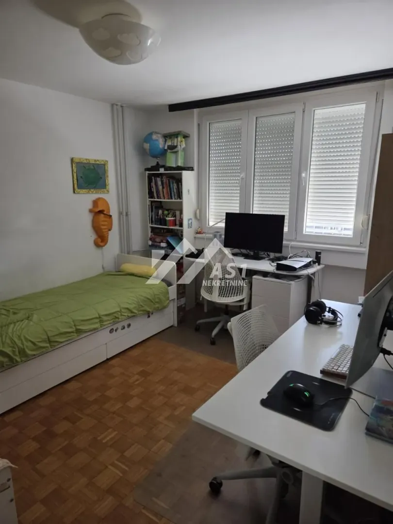 Dečja soba sa krevetom i radnim stolom.