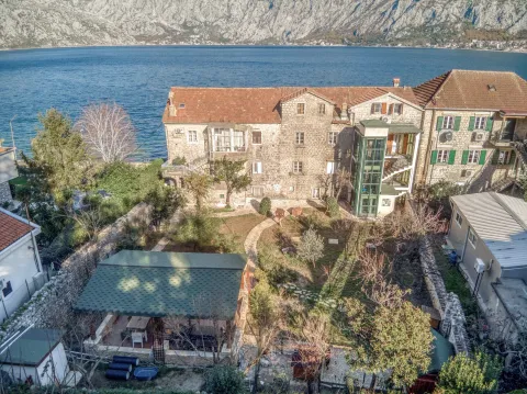 Aerial view of a stone house with a courtyard and sea view. - image 7