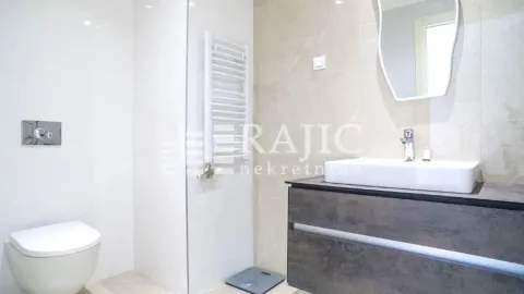 Modern bathroom with washbasin, toilet, and shower cabin. - image 8
