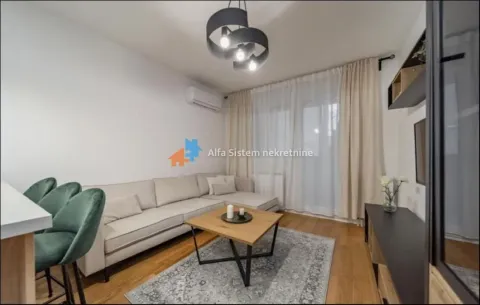 Living room with a sofa, coffee table, and dining table with chairs. - image 2