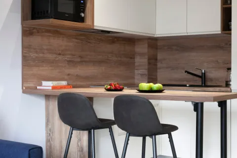 Modern kitchen with wooden elements and a bar counter. - image 5