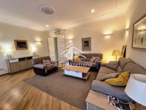 Living room furnished with a sofa set, armchair, and coffee table. - image 3