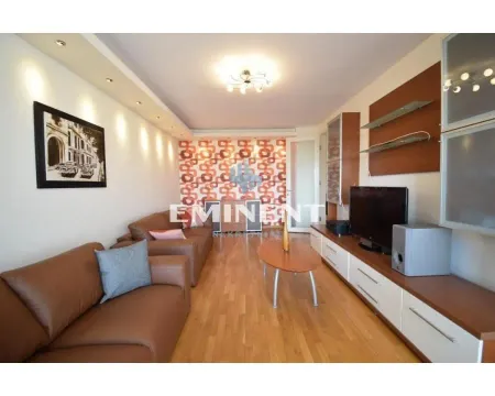 Living room with sofa seating, TV unit, and wooden flooring. - image 3