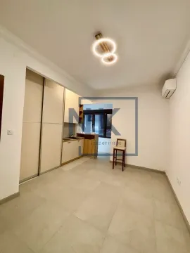 Small kitchen with built-in closets and a bar counter in bright tones. - image 3