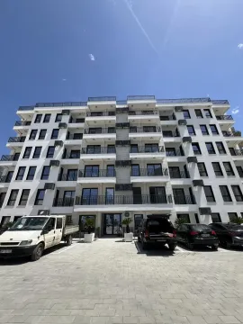 Exterior of a modern residential building with front parking. - image 5