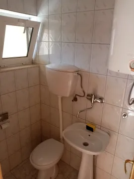 Small bathroom with a toilet and a sink. - image 15