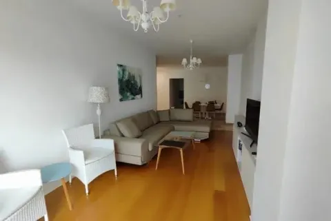 Bright living room with a sectional sofa and dining area in the background. - image 10