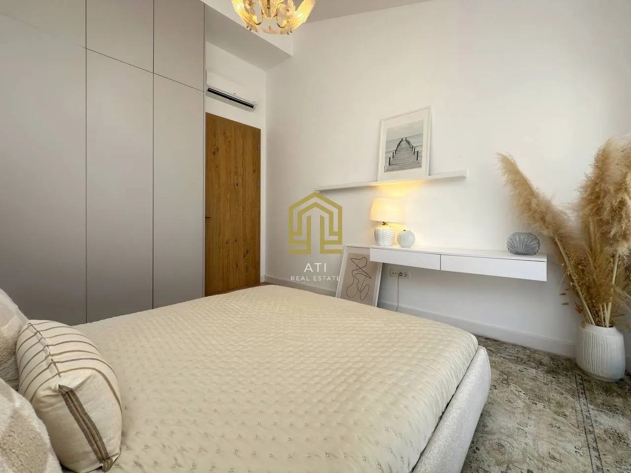 Modern bedroom with a double bed, built-in wardrobe, and decorative details.