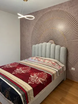 Modern bedroom with a double bed and a decorative wall panel. - image 7