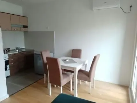 Living room with dining area and kitchen in the background. - image 8
