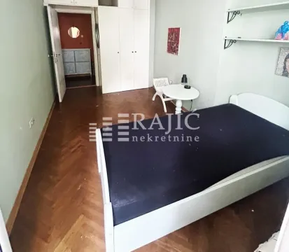Furnished bedroom with a bed and wardrobe. - image 9
