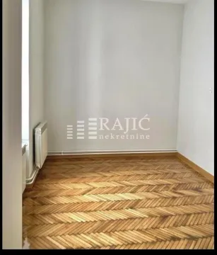 Empty room with parquet flooring and white walls. - image 4