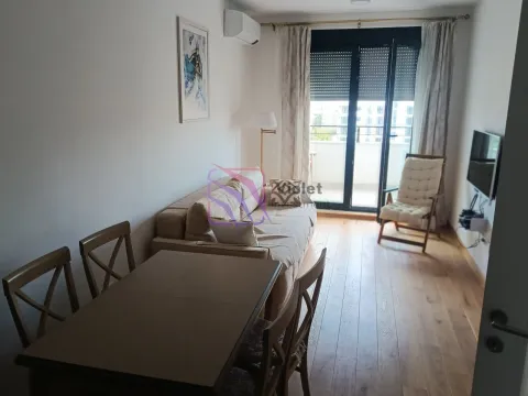 Living room with a sofa, dining table, and access to the terrace. - image 2