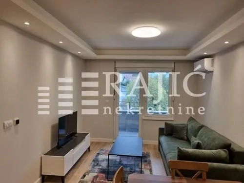 Furnished living room with a sofa and television.