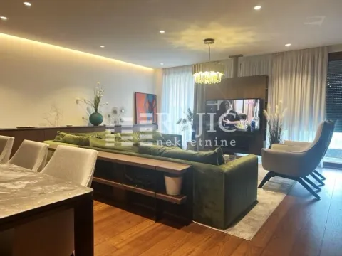 Modern and spacious living room with a sofa and dining area. - image 12