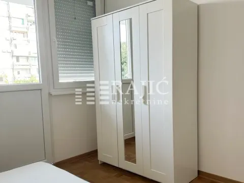 Bedroom with a white wardrobe and a mirror. - image 3