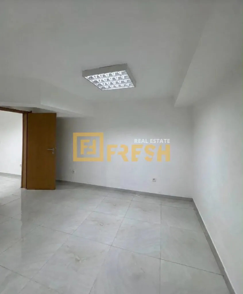 Empty room with white walls and tiled floor.
