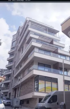 Exterior view of a modern multi-story residential building with balconies. - image 12