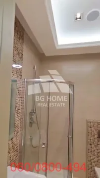 Bathroom equipped with a glass shower enclosure and decorative mosaic tiles. - image 15