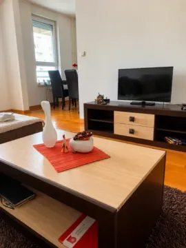 Living room with a TV unit and a coffee table. - image 11