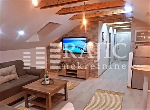 Living room with sofa and TV in the attic.