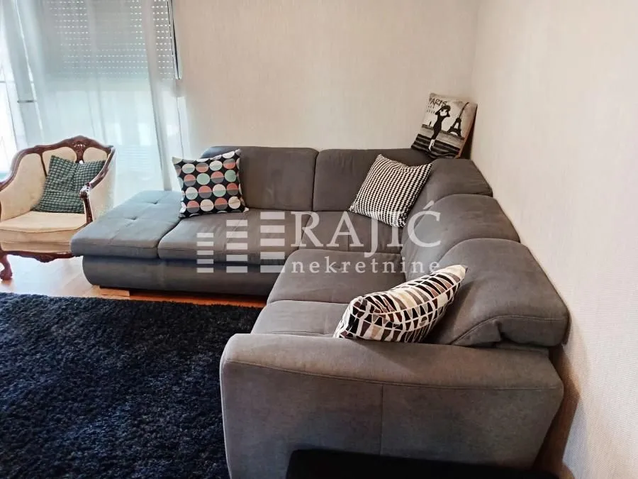 Comfortable living room with a sectional sofa and an armchair.
