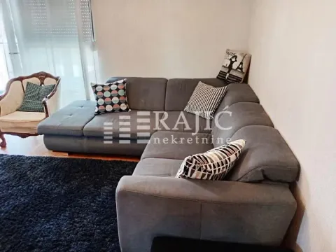 Comfortable living room with a sectional sofa and an armchair. - image 4
