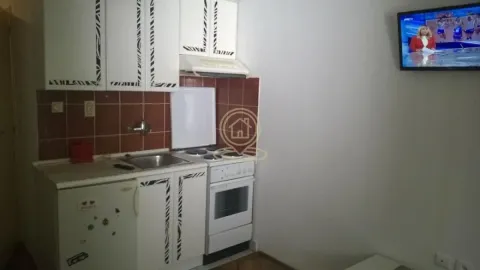Small kitchen with white cabinets and a stove. - image 5