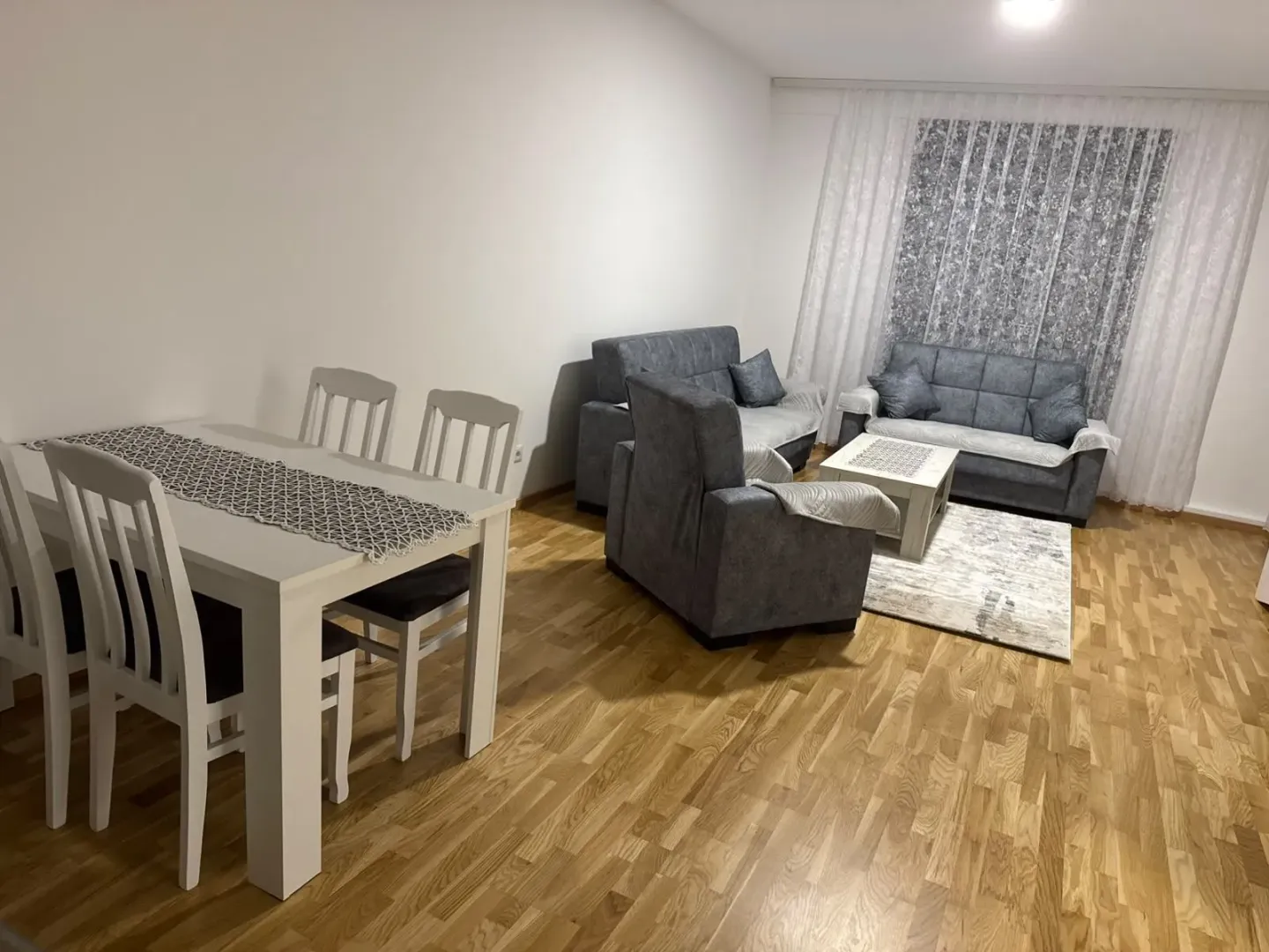 Spacious living room with a sofa set and dining table.