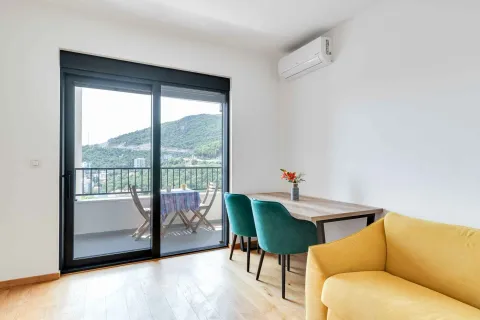 Living room with a dining table and access to the terrace. - image 6