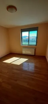 Empty room with hardwood floors and a window overlooking the surroundings. - image 11