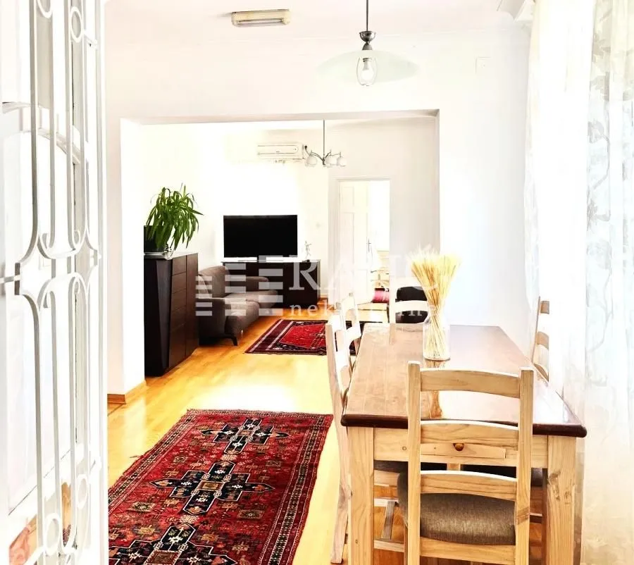 Living room with a dining area and a wooden table.
