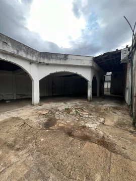 Exterior of an abandoned building with a covered porch and damaged concrete yard. - image 9