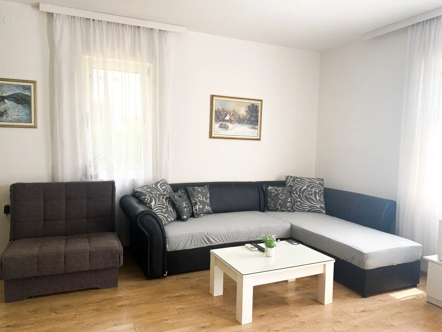 Living room with a sectional sofa, armchair, and coffee table.