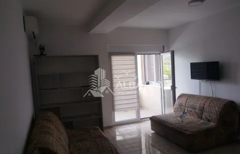 Living room with sofas, shelving unit and access to the terrace. - image 2